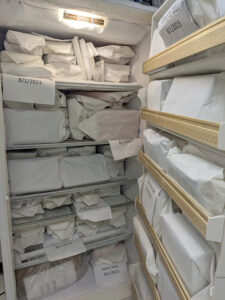 A freezer with wet books wrapped in paper.